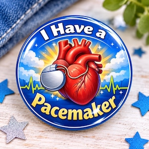 May include: A round button featuring a red anatomical heart connected to a silver pacemaker device. The background is a blue sky with clouds, yellow sunburst rays, and a green EKG line. The text reads I Have a Pacemaker in bold yellow letters.