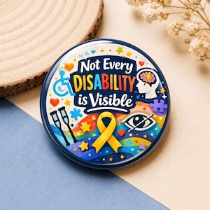 May include: A round pinback button featuring the text Not Every DISABILITY is Visible in blue and orange. The design includes a blue wheelchair icon, a brain with a lightning bolt, crutches, a yellow awareness ribbon, and a stylised eye.
