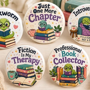 May include: Five circular pinback badges displaying illustrations of green worms reading books. Text includes Bookworm, Just One More Chapter, Introverting... It's a Feature, Not a Bug, Fiction Is My Therapy, and Professional Book Collector with colourful book stacks.