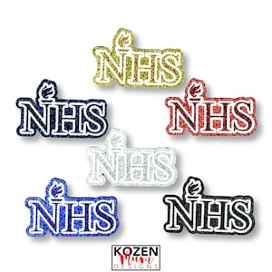 May include: Five glittery NHS patches with a torch icon above the letters. The patches are arranged in a cluster and come in gold, dark blue, red, silver, and black colors. Each patch features a bold outline and a sparkling texture throughout.