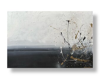 Op de afbeelding: Abstract schilderij met zwarte en gouden spatten op een witte achtergrond. De onderste helft van het schilderij is donkergrijs.