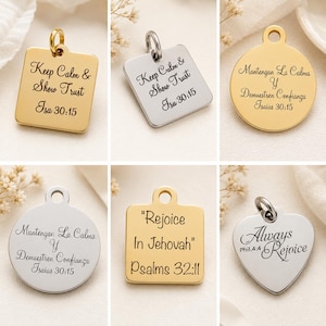 May include: A collection of six metal jewelry charms in gold and silver tones, featuring square, circular, and heart shapes. Each charm is engraved with religious text including Keep Calm & Show Trust Isa 30:15, Mantengan La Calma Y Demuestren Confianza Isaias 30:15, Rejoice In Jehovah Psalms 32:11, and Always Rejoice Phil.4:4.