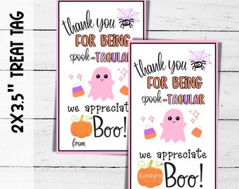 May include: Two Halloween-themed treat tags with pink borders. Each tag features the text "thank you for being spook-tacular" and a cute pink ghost illustration. Additional graphics include a spider web, candy corn, and a pumpkin.