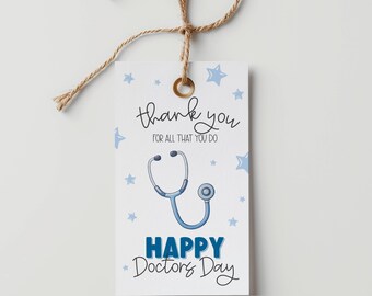 May include: A white gift tag with a brown string, featuring the text "thank you" and "for all that you do". A blue stethoscope graphic and the words "HAPPY Doctors Day" are also present. Blue stars decorate the tag.