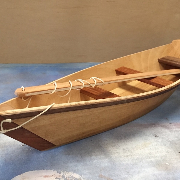 Toy boat with string and play stick - clear finish.  For play indoors or out in the water.  Made with various hardwoods & plywood.