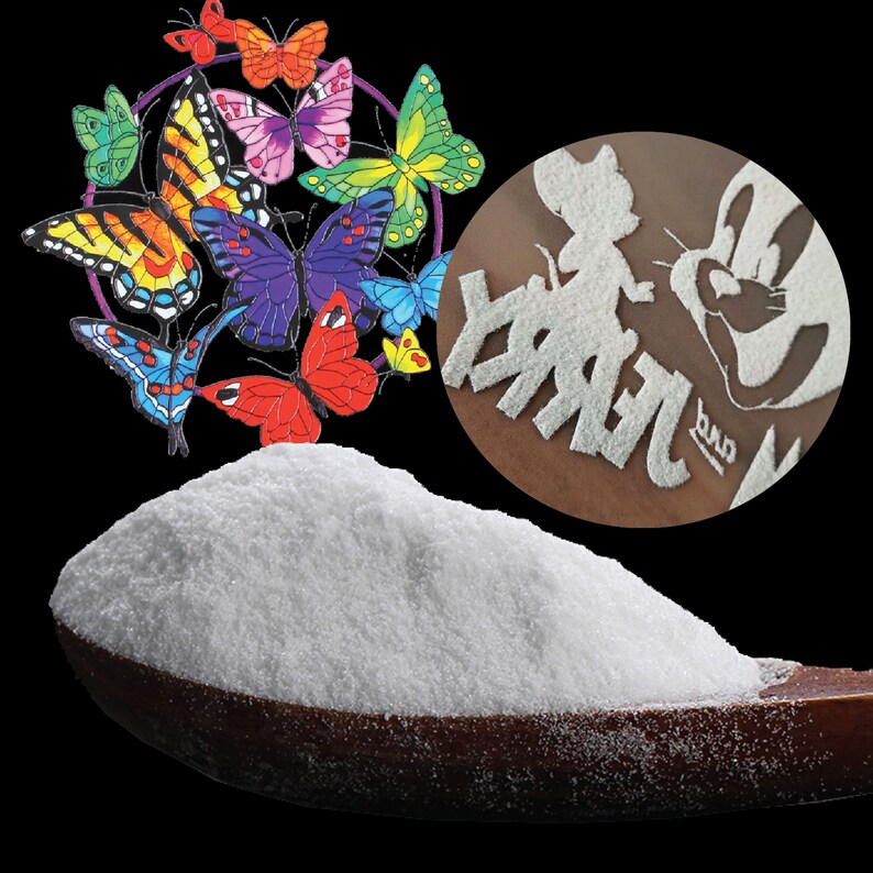 May include: A wooden spoon holds a mound of white powder, with a colorful butterfly decoration and a circular design featuring a cartoon character. The butterflies are in various colors, including red, blue, and yellow.