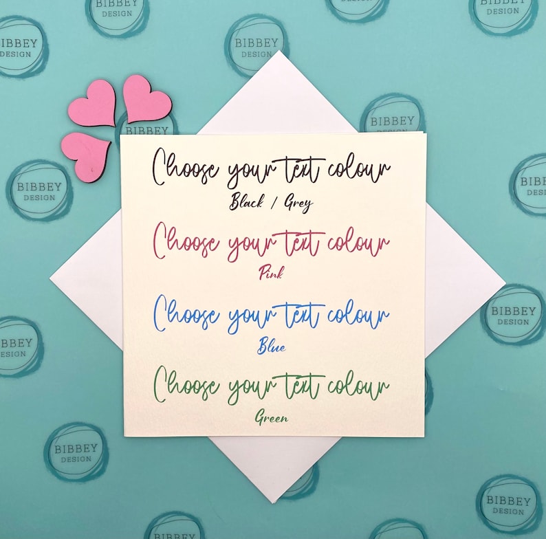 May include: A white card with the text "Choose your text colour" in black, followed by four options: "Black/Grey", "Pink", "Blue", and "Green". Each option is written in the corresponding colour.