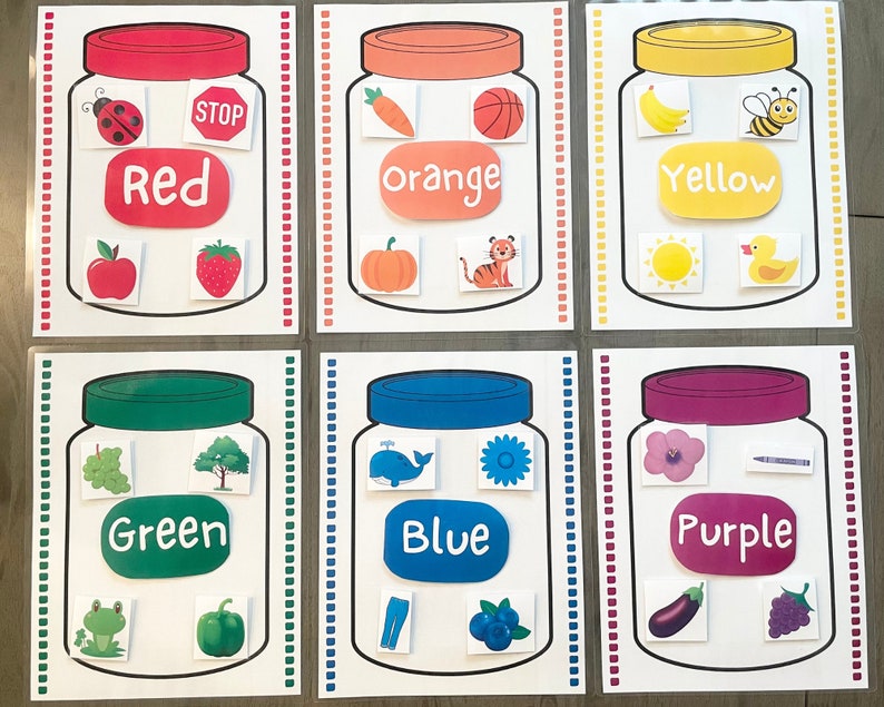 May include: Six printable color matching activity cards featuring jars with lids in different colors. Each jar has a color word and four images of objects in that color. The colors are red, orange, yellow, green, blue, and purple.