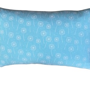 May include: A light blue pillow with a white dandelion pattern.