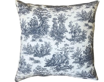 May include: A white pillow with a blue toile pattern featuring a repeating design of people and trees.