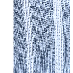 May include: Close-up of a blue and white striped fabric with a textured weave.