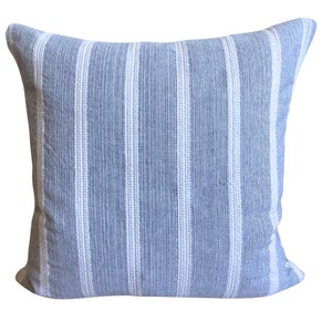 May include: A blue and white striped throw pillow with a soft, textured fabric.