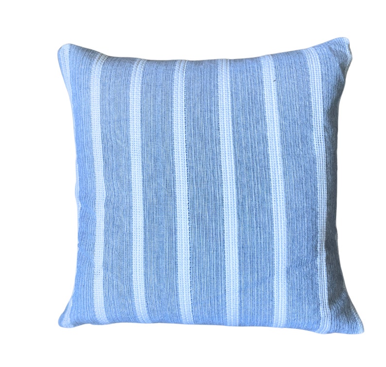 May include: A blue and white striped throw pillow with a soft, textured fabric.