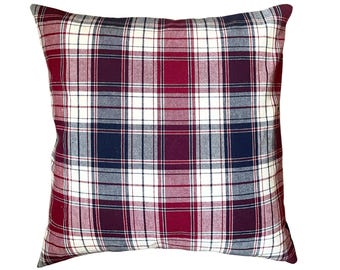 May include: Red, white, and blue plaid throw pillow. The pillow is made of a soft, woven fabric.