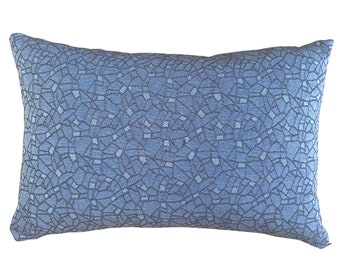 May include: A blue rectangular pillow with a geometric pattern. The pattern is made up of small, light blue squares and dark blue lines.