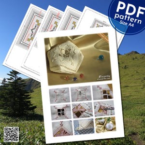 May include: A white biscornu, a type of padded, hexagonal box, with a star-shaped design. The biscornu is shown on a gold fabric background. The image also includes a close-up of the stitching pattern for the biscornu, showing the steps for creating the design.