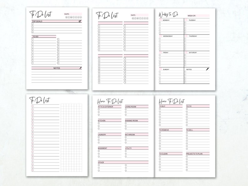 May include: A set of white to-do list notebooks with pink accents. The notebooks feature sections for daily, weekly, and home tasks, with headings like "Top Goals," "To Do," and "Notes." The text is in a handwritten style.