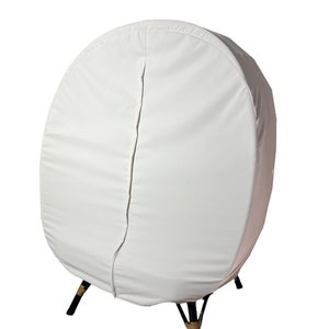 May include: White egg-shaped chair cover with a zipper down the back. The cover is made of a soft, white fabric and has a simple design. The chair has black legs with a brown rope detail.