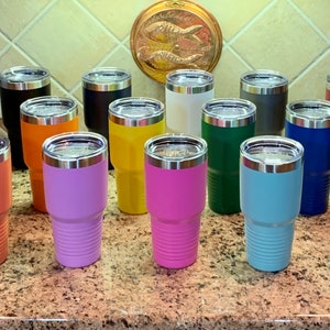 May include: A collection of 16 stainless steel tumblers in various colors, including orange, purple, yellow, pink, blue, and green. The tumblers have a double-wall design and a lid.