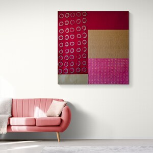 May include: Abstract art painting with a red background and a pattern of white circles. The painting is divided into three sections, with a gold section in the middle and a pink section at the bottom.
