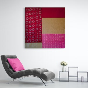 May include: Abstract art painting with a red, pink, and gold color scheme. The painting features a geometric pattern of circles and squares.