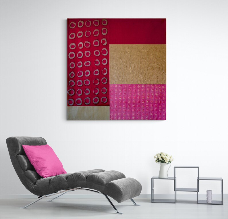 May include: Abstract art painting with a red, pink, and gold color scheme. The painting features a geometric pattern of circles and squares.