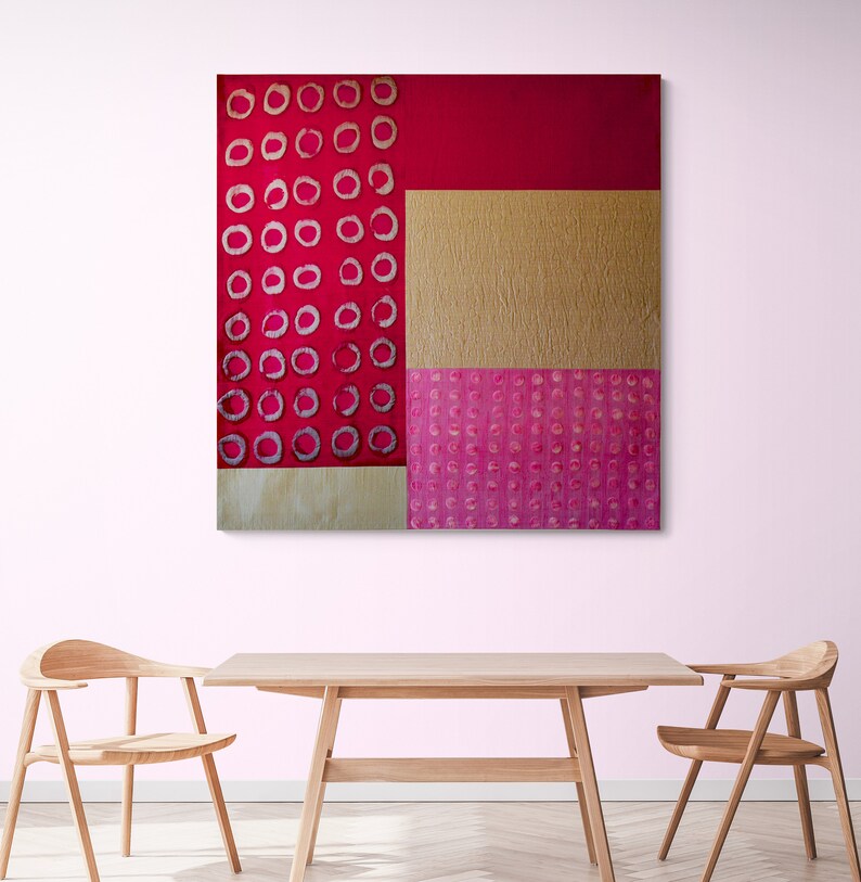 May include: Abstract art painting with a red, pink, and gold color scheme. The painting features a geometric pattern of circles and squares.
