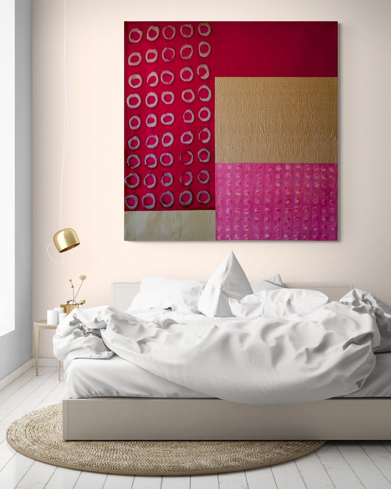 May include: Abstract art painting with a red, gold, and pink color scheme. The painting features a geometric design with circles and squares.