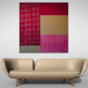 May include: Abstract art painting with a geometric design. The painting features a red background with a gold and pink pattern.