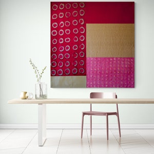 May include: Abstract art painting with a geometric design of red, pink, and gold. The painting features a pattern of circles in different shades of pink.