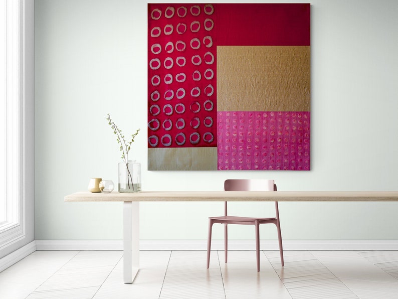 May include: Abstract art painting with a geometric design of red, pink, and gold. The painting features a pattern of circles in different shades of pink.
