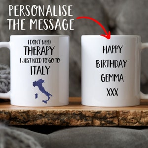 May include: Two white ceramic mugs. One mug has the text "I don't need therapy I just need to go to Italy" with a blue outline of Italy. The other mug has the text "Happy Birthday Gemma XXX".