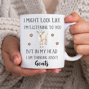 May include: White ceramic mug with a black and white goat illustration and the text "I might look like I'm listening to you but in my head I am thinking about goats".