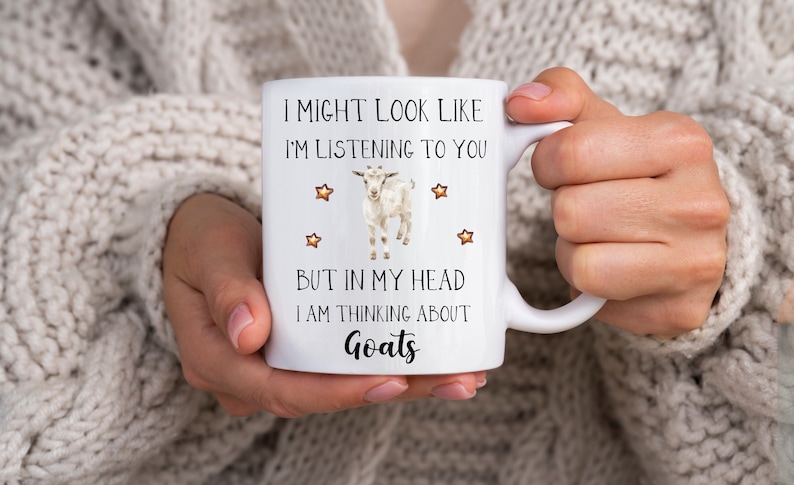 May include: White ceramic mug with a black and white goat illustration and the text "I might look like I'm listening to you but in my head I am thinking about goats".