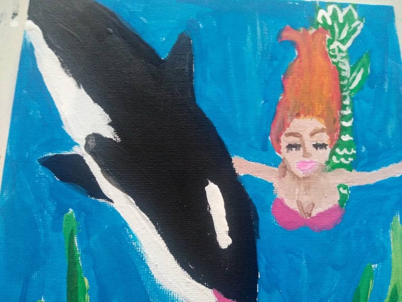 Mermaid swimming with an orca whale