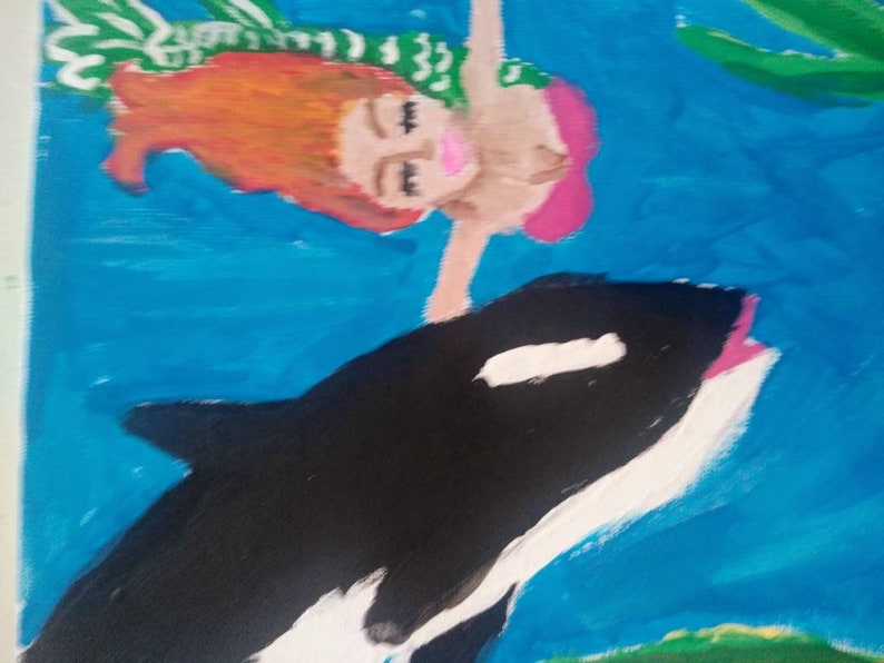 Mermaid swimming with an orca whale