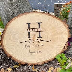 May include: A wooden slice with the letters "HIGHT" in a split monogram design, with the names "Cody & Morgan" and the date "August 23, 2020" engraved below.