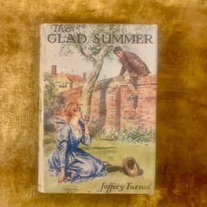 May include: The cover of a vintage book titled "The Glad Summer" by Jeffery Farnol. The cover features a watercolor illustration of a young woman in a blue dress sitting on the ground and a young man in brown clothes standing on a brick wall. The man is looking down at the woman.