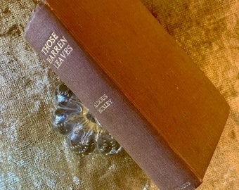 May include: A brown hardcover book titled "Those Barren Leaves" by Aldous Huxley.
