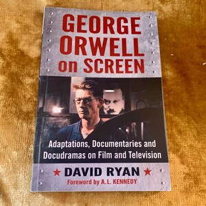 May include: A book titled "GEORGE ORWELL on SCREEN" with a photo of a man wearing glasses. The book cover has the text "Adaptations, Documentaries and Docudramas on Film and Television" and "DAVID RYAN".