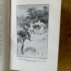 May include: A black and white illustration of a scene from a book. A man in a hooded robe is running away from a man with a bow and arrow. A woman in a long dress is standing in the background.