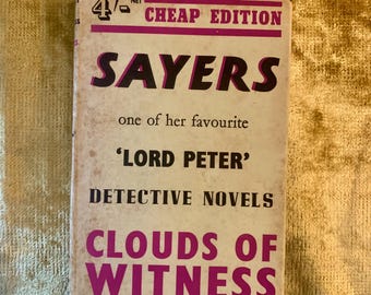 May include: Vintage paperback book titled "Sayers" with "Clouds of Witness" on the cover. The cover is off-white with black and magenta text. The book is a "Cheap Edition" and features "Lord Peter" detective novels.