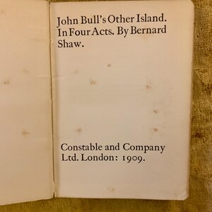 May include: A close-up of a book cover with the title "John Bull's Other Island" by Bernard Shaw. The book was published by Constable and Company Ltd. in London in 1909.