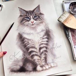 May include: A watercolor painting of a long-haired grey and white tabby cat with striking blue eyes. The cat is depicted in a seated position, facing forward. The artwork features the cursive text @KathleensWatercolor and a signature in the corner.