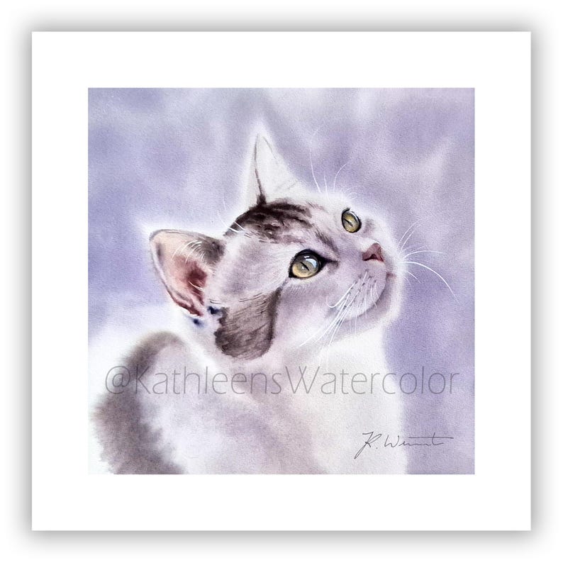 May include: A watercolor painting of a cat with white and grey fur looking upward. The cat has light green eyes and long white whiskers. The background is a soft, blended purple wash. The text @KathleensWatercolor and a signature are visible.