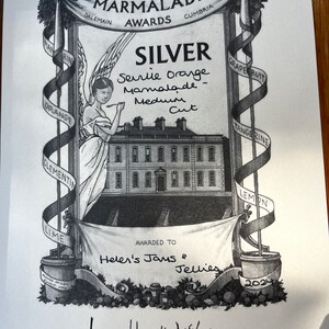 May include: Black and white award certificate for "The World's Original Marmalade Awards." The certificate features an illustration of a building, an angel, and ribbons with fruit names. Awarded to Helen's Jams & Jellies for Seville Orange Marmalade, Medium Cut, Silver.