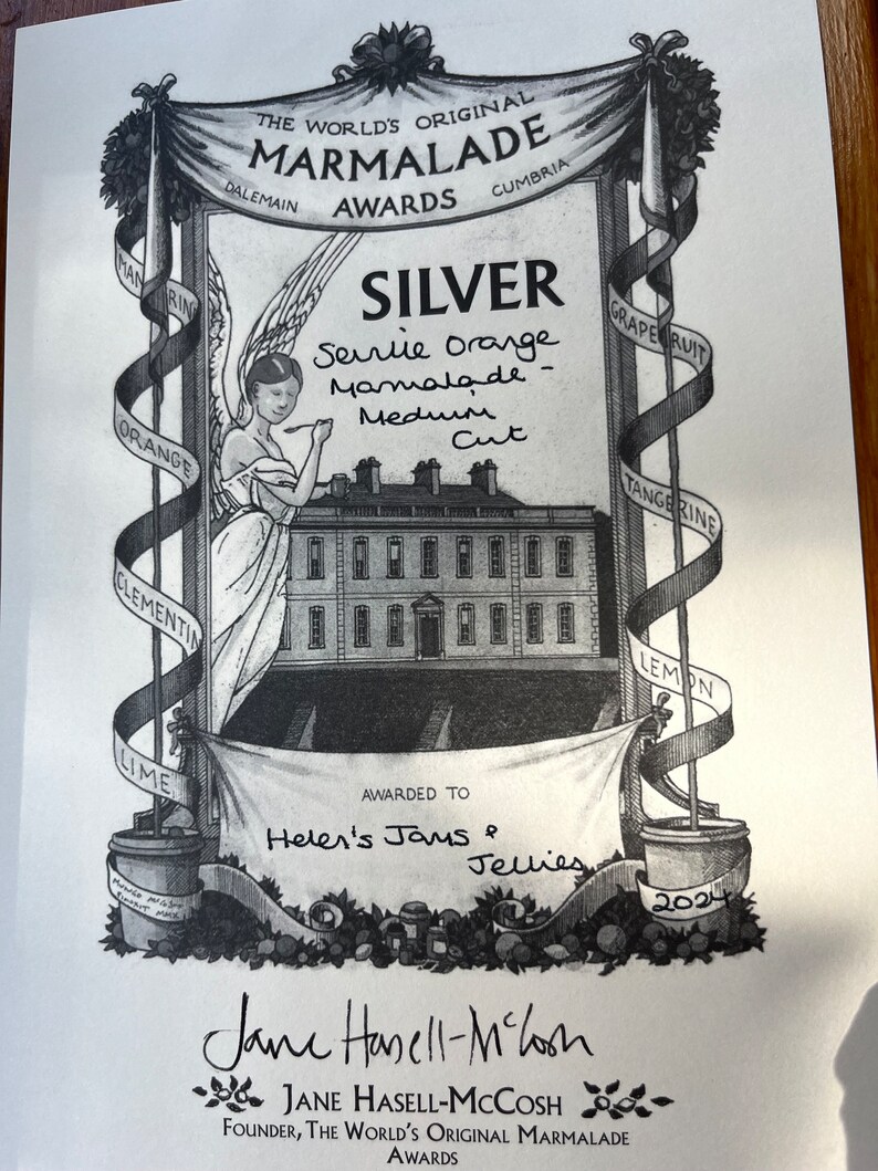May include: Black and white award certificate for "The World's Original Marmalade Awards." The certificate features an illustration of a building, an angel, and ribbons with fruit names. Awarded to Helen's Jams & Jellies for Seville Orange Marmalade, Medium Cut, Silver.
