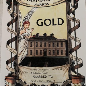 May include: An award certificate for the World's Original Marmalade Awards. The illustration features an angel, a building, and ribbons with fruit names. The certificate reads "GOLD" and is for "Helen's Jams & Jellies."