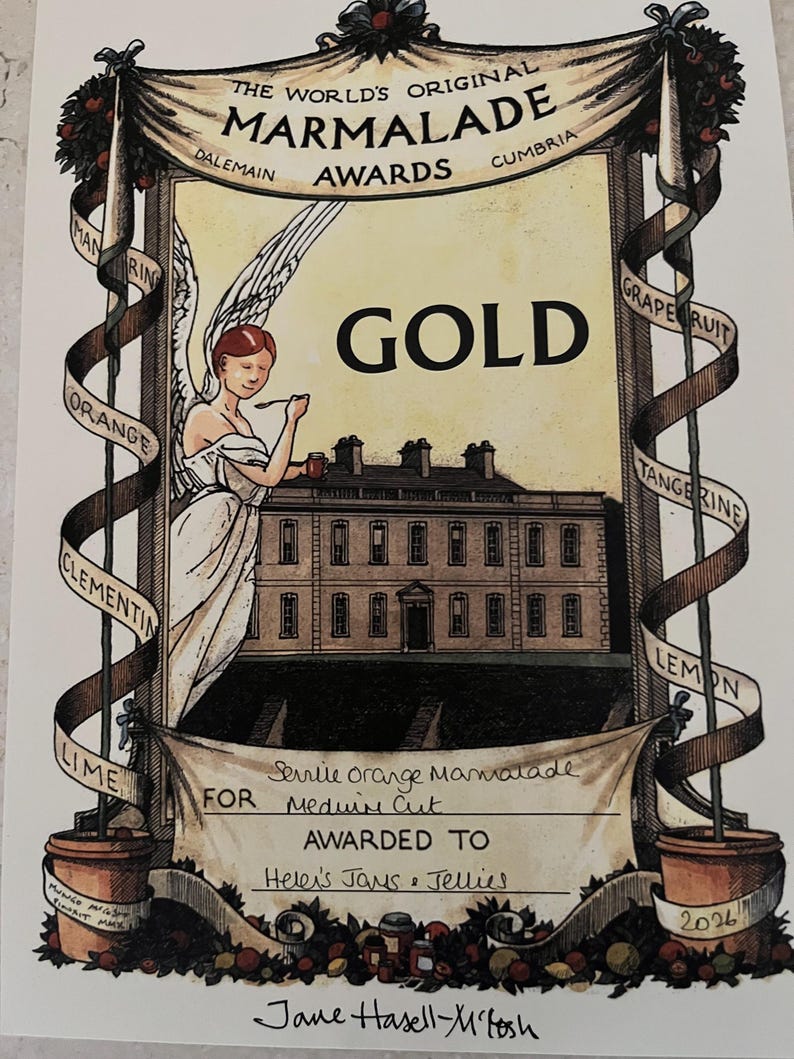 May include: An award certificate for the World's Original Marmalade Awards. The illustration features an angel, a building, and ribbons with fruit names. The certificate reads "GOLD" and is for "Helen's Jams & Jellies."