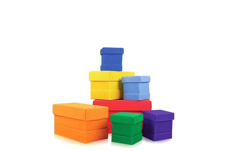 May include: A collection of colorful, stacked gift boxes in various sizes and hues, including orange, yellow, red, green, blue, and purple. The boxes are arranged in a visually appealing pyramid shape against a white background.